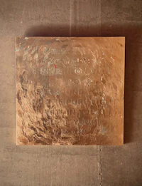 a large piece of metal hanging on a wall