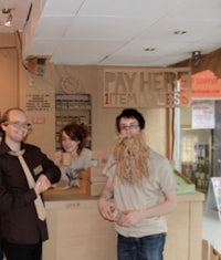 a group of people standing in front of a cardboard store