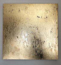 a gold painting on a white wall